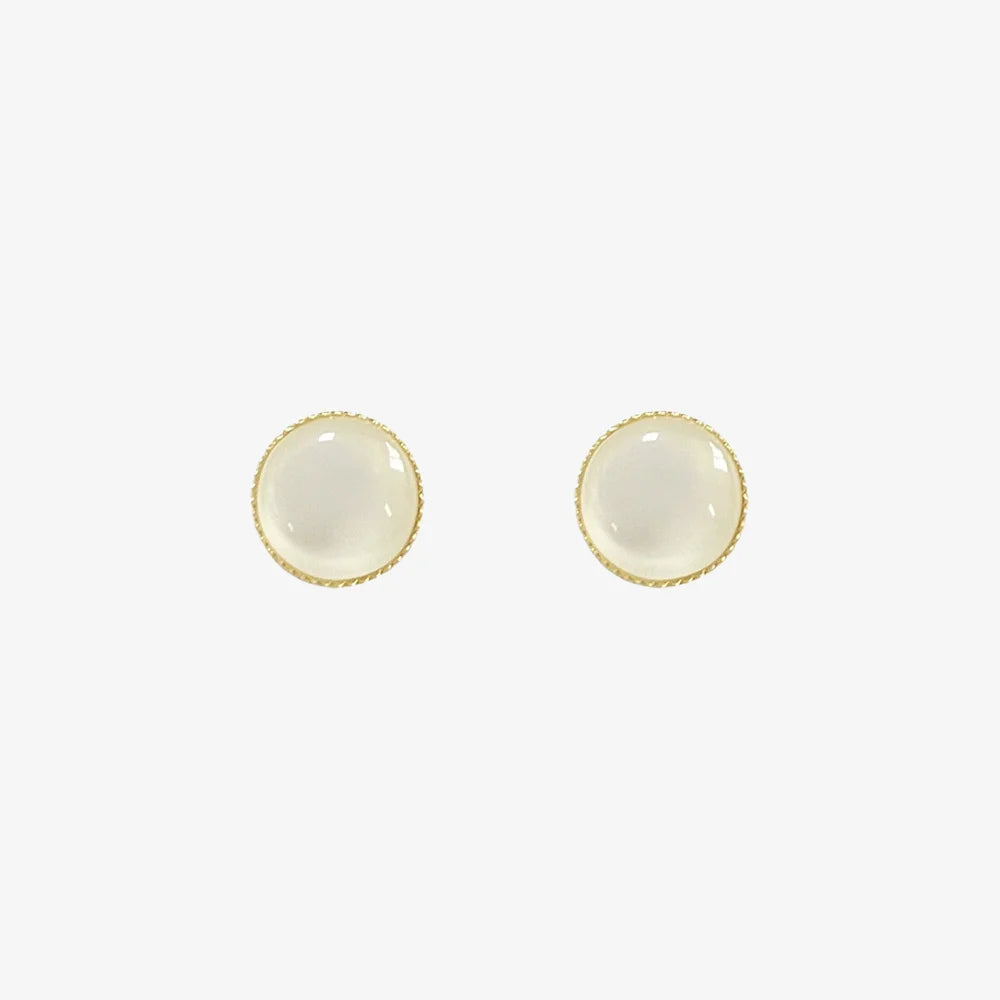 A pair of no-piercing Frosted Moonstone invisible clip-on stud earrings, with their luminous white stones, isolated on a white background.