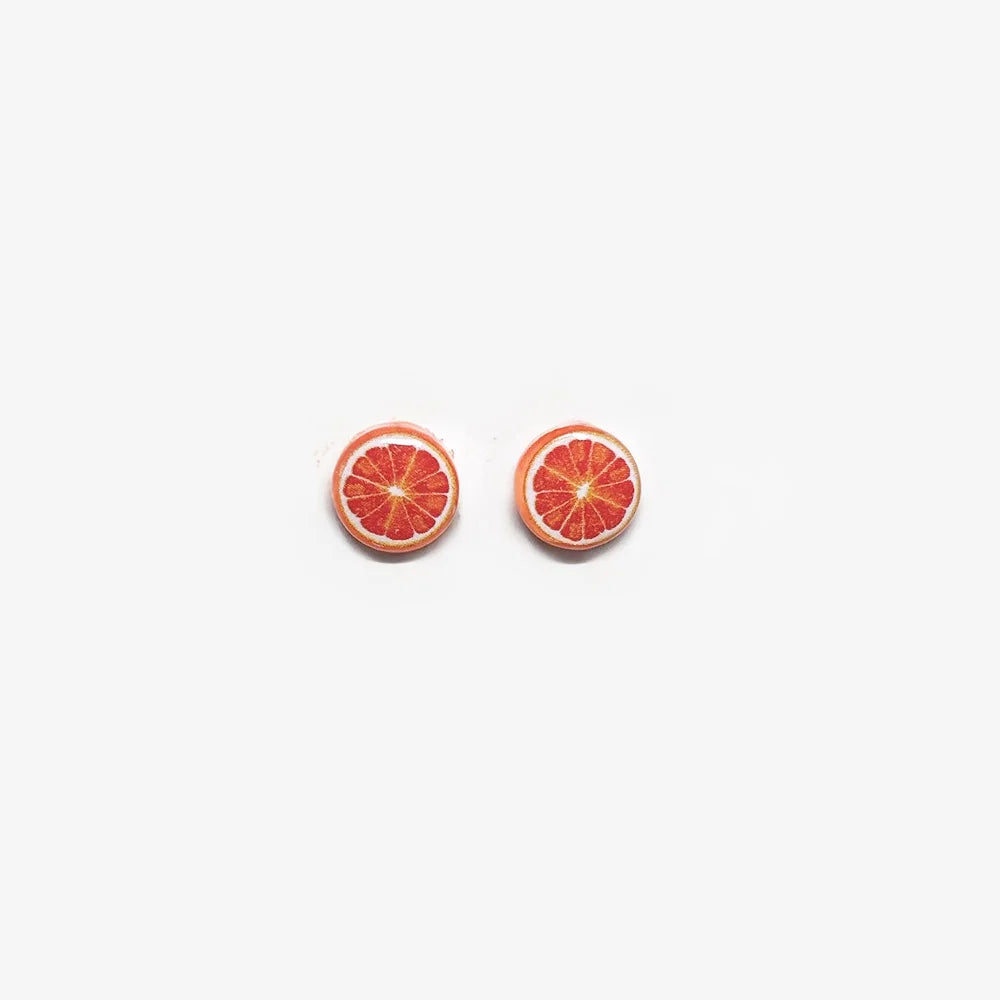 A pair of no-piercing Zesty Grapefruit Magnetic Stud Earrings, showcasing their detailed resin fruit slice design, isolated on a white background.