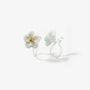 Close-up detail of a resin flower earring for non-pierced ears showing the transparent invisible clip-on back and pearlescent finish.