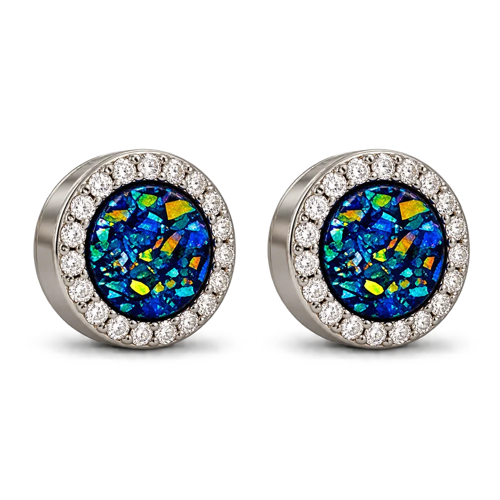 A pair of round stud earrings featuring iridescent blue and green opal-like center stones surrounded by a halo of small clear stones in a silver-toned setting, shown on a plain white background.