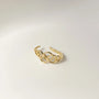 A detailed product shot of the gold lobe cuff, highlighting the openwork pattern of linked circles.