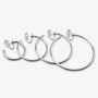 Silver-tone hoop clip-on earrings in a range of sizes lined up from smallest to largest