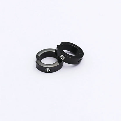 A pair of black spring-loaded clip-on hoop earrings with a subtle zircon accent, styled together on a clean white background.