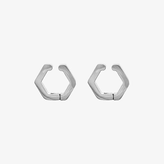 A pair of polished silver hexagon geometric clip-on earrings, made from titanium steel, shown on a clean white background.