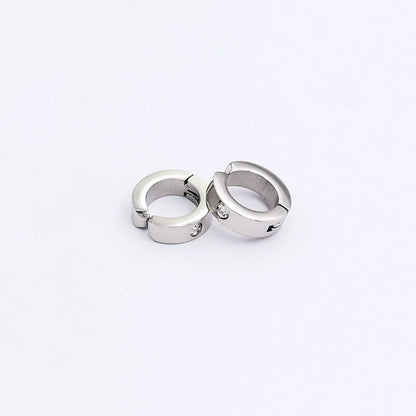 A pair of silver spring-loaded clip-on hoop earrings with a subtle zircon accent, styled together on a clean white background.