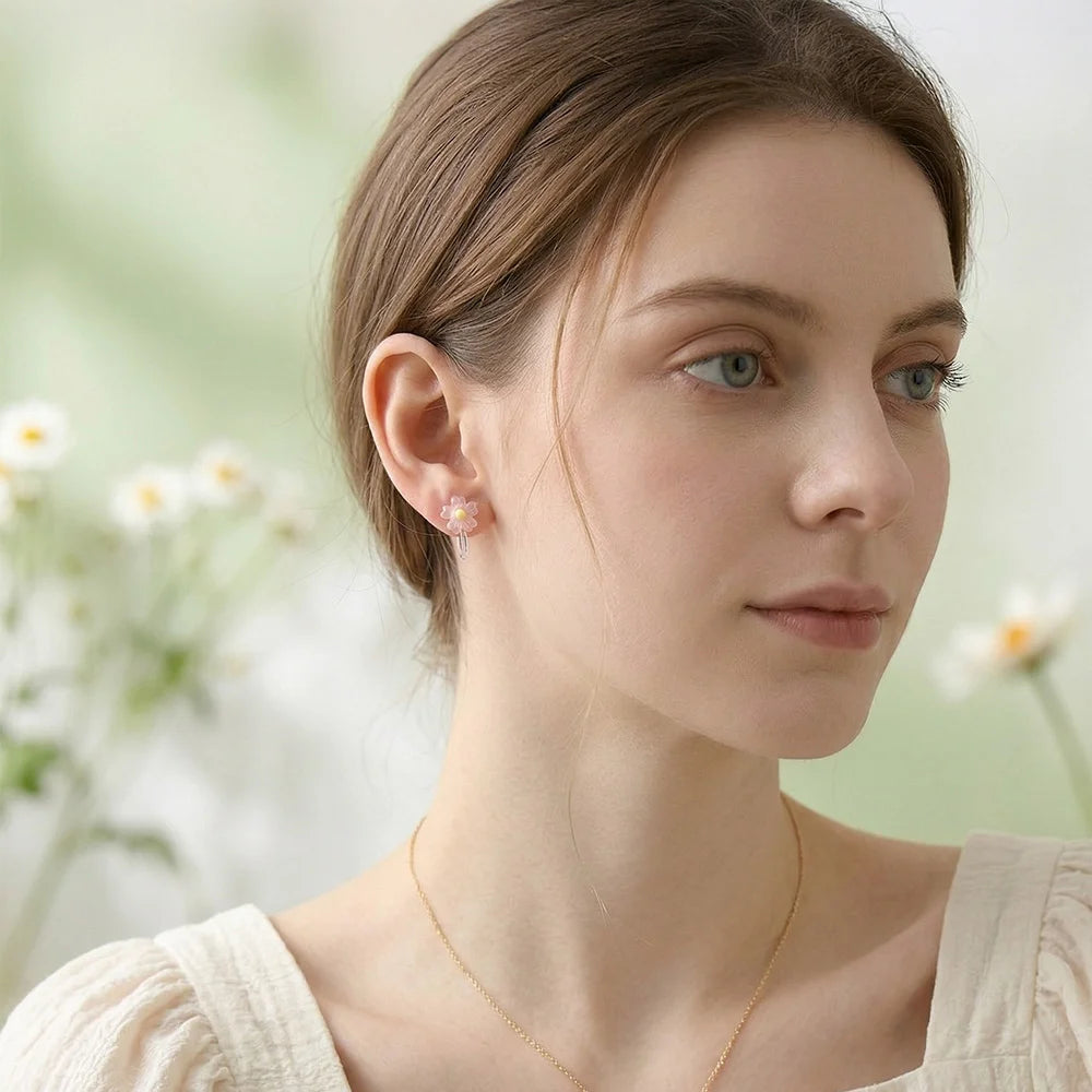 Model wearing the pink daisy candy color earrings to show the bloomcore aesthetic and perfect sizing.