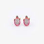 Front view of a pair of pink enamel pitaya dragon fruit magnetic clip-on stud earrings showing detailed white flesh and black seeds.