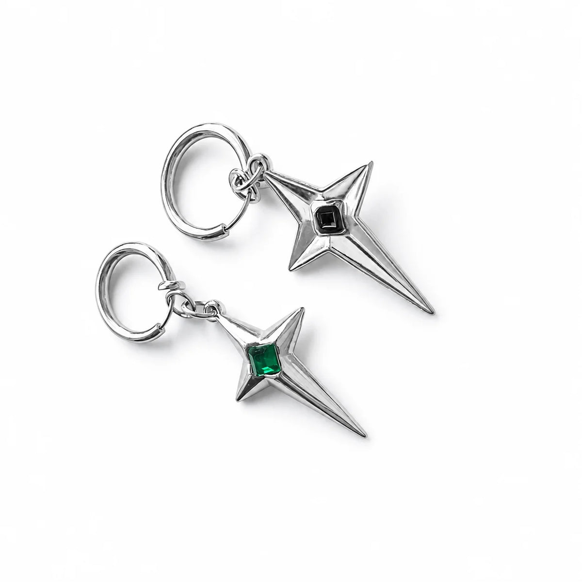 Pair of polaris star clip-on earrings on a white surface, one showing the front view with a green gem and the other showing the back view of the green gem version.