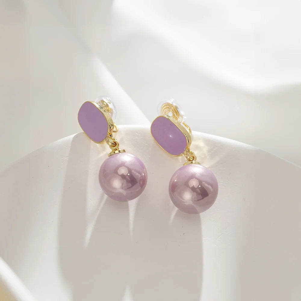 Detailed view of one Purple Pearl Clip-On Drop Earring, highlighting the lustrous purple pearl and secure U-type clip-on closure.