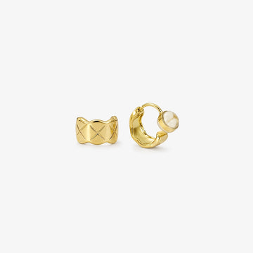 A pair of gold-toned quilted huggie clip on earrings featuring a lattice etched pattern.