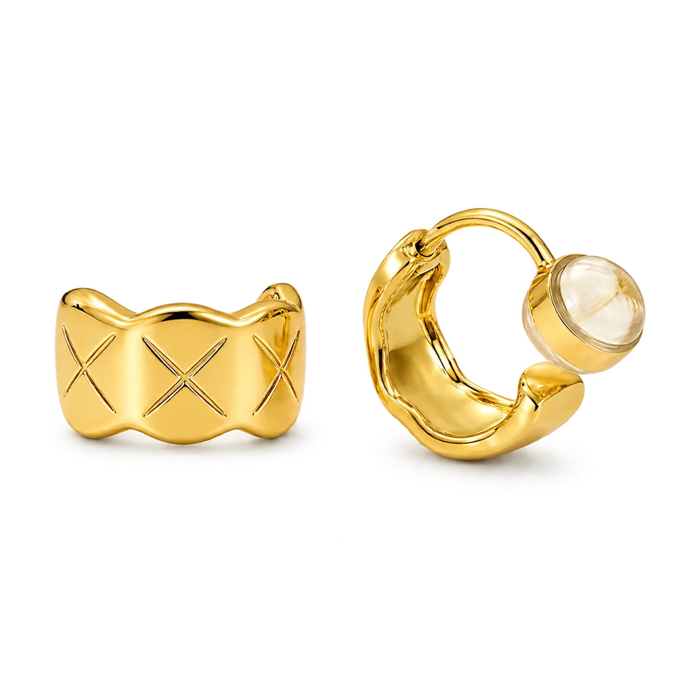 A pair of gold-toned quilted huggie clip on earrings featuring a lattice etched pattern.