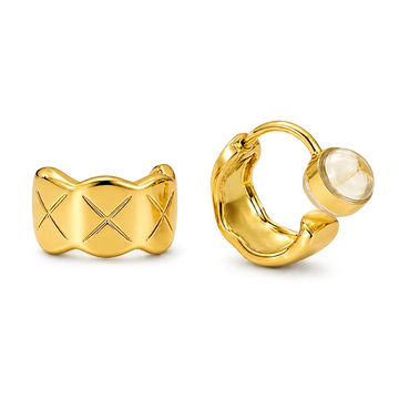 A pair of gold-toned quilted huggie clip on earrings featuring a lattice etched pattern.