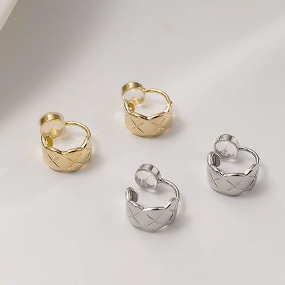 A collection of quilted huggie clip on earrings displayed in both white gold and gold finishes.