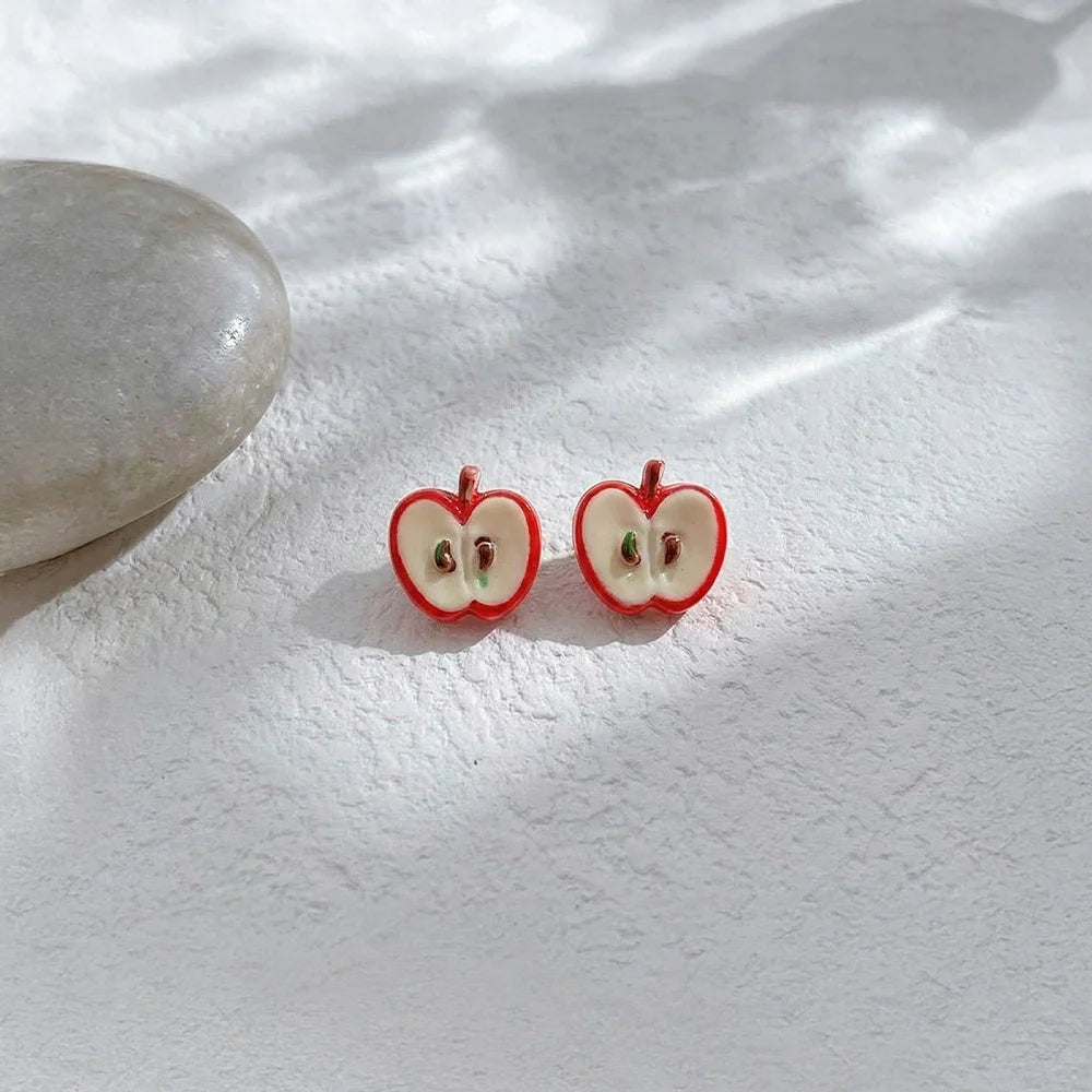 Detailed view of the apple slice resin jewelry showing the magnetic clip-on mechanism for non-pierced ears.