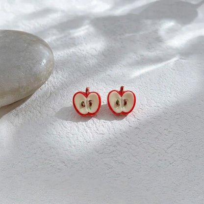 Detailed view of the apple slice resin jewelry showing the magnetic clip-on mechanism for non-pierced ears.