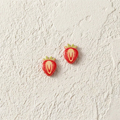 Detailed view of the strawberry slice resin earrings highlighting the glossy texture and secure magnetic clip-on mechanism.