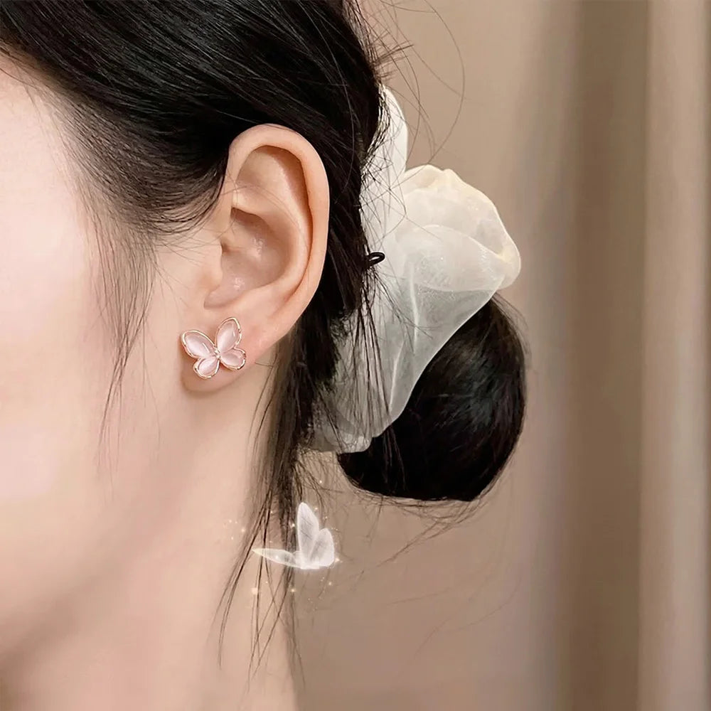 A model wearing a dainty rose gold butterfly magnetic stud earring, demonstrating a realistic non-pierced look.