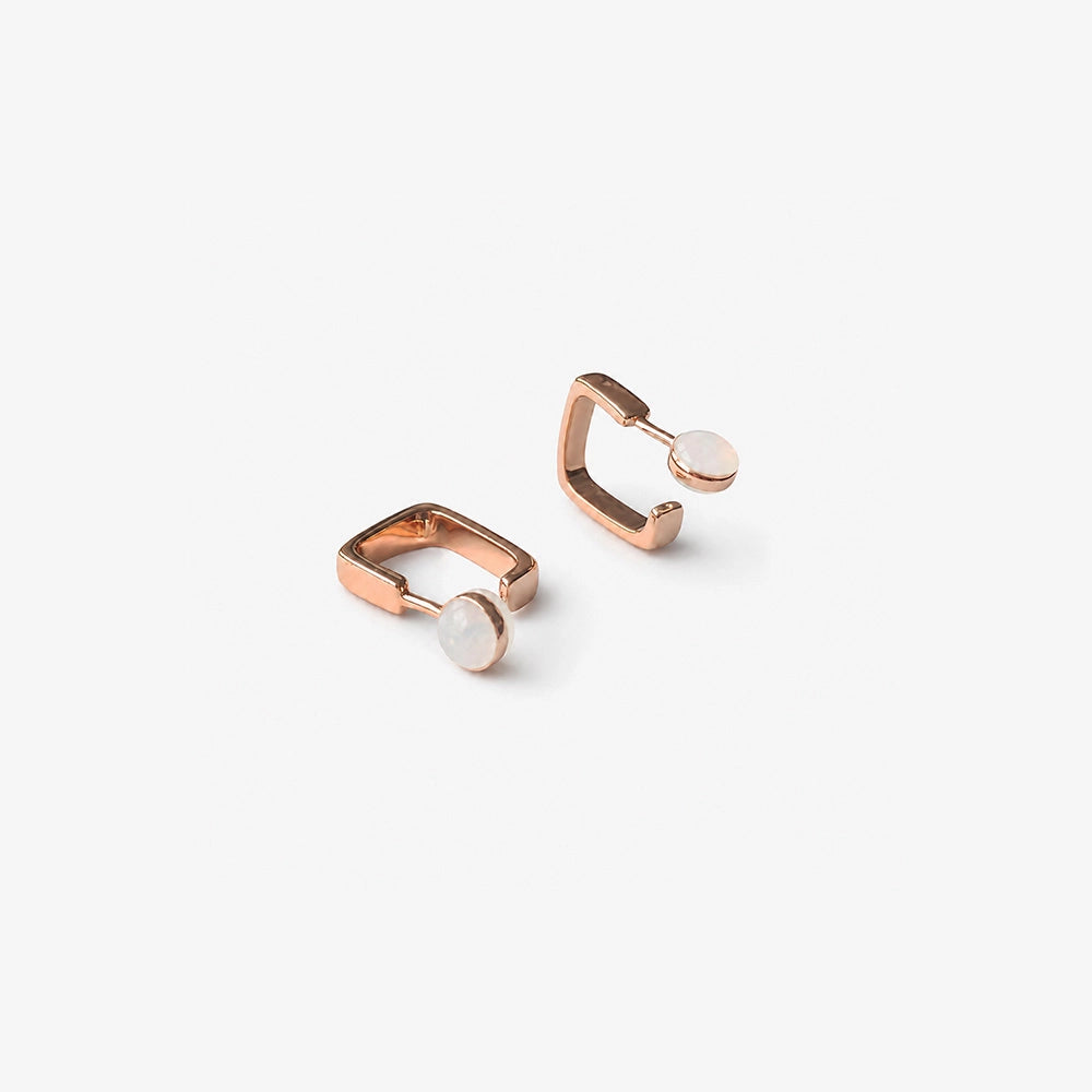 Angled view of rose gold square clip on hoop earrings for non pierced ears