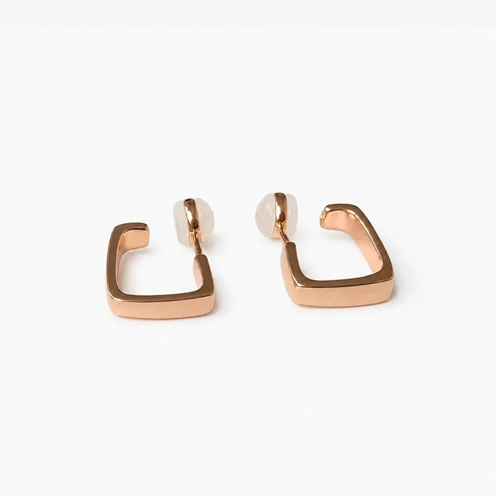 Close up detail of the geometric square band on rose gold clip on hoop earrings