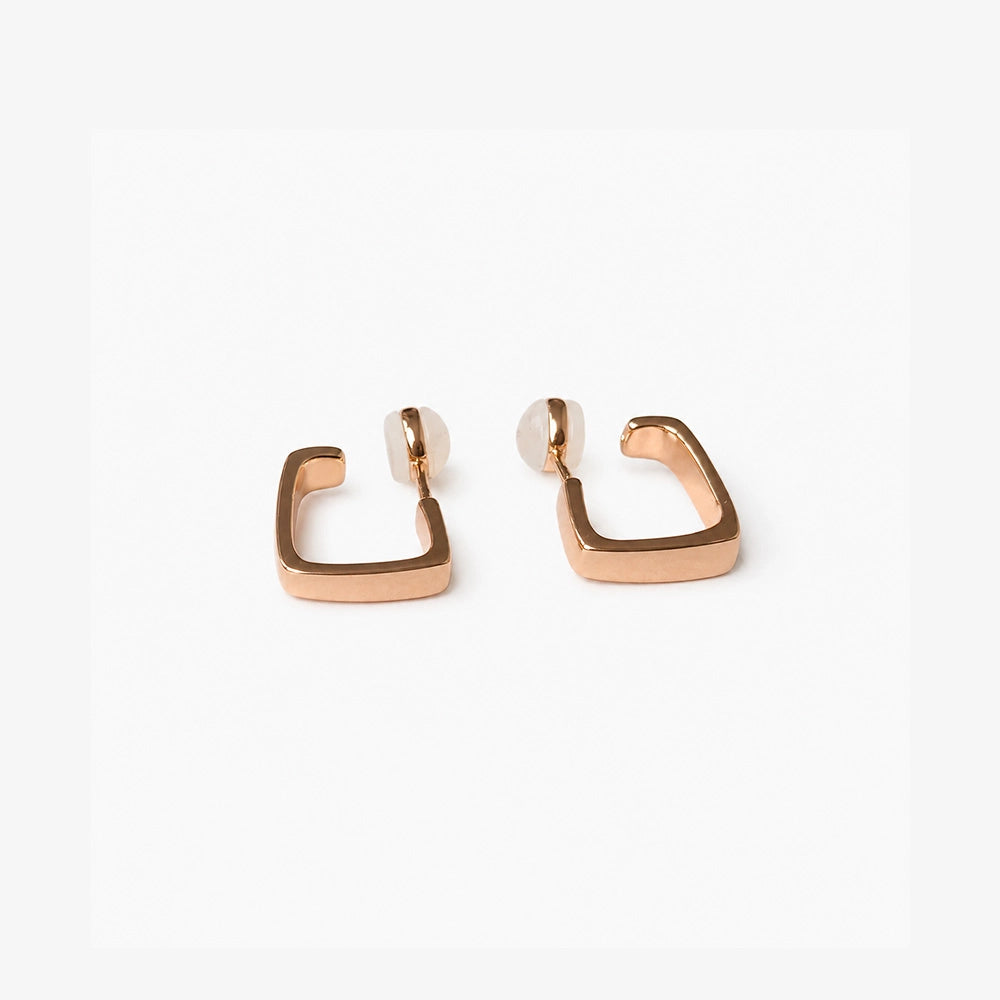 Close up detail of the geometric square band on rose gold clip on hoop earrings