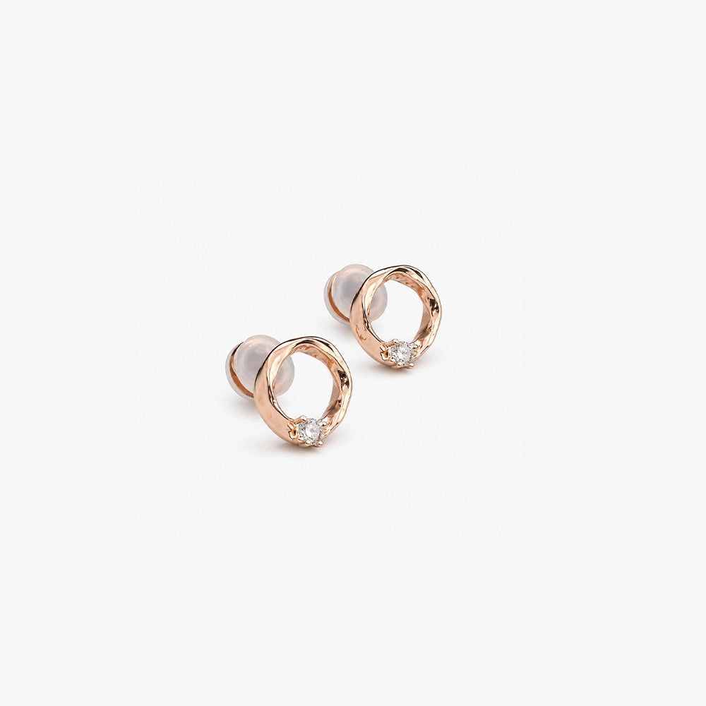 Pair of dainty rose gold twisted circle earrings with a small solitaire stone, perfect for luxury everyday wear.