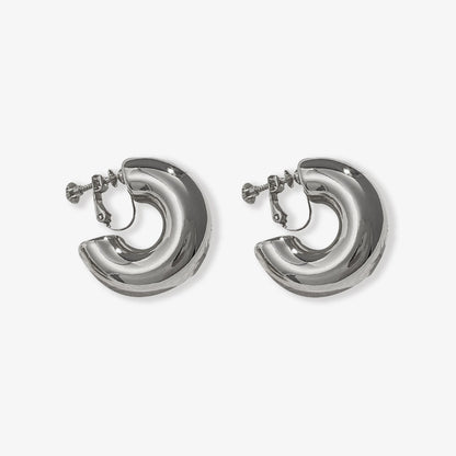 Sleek modern silver-tone bold hoop clip-on earrings, crafted from a high-quality copper alloy, featuring a sturdy screw-back closure. These huggie earrings are designed to add a touch of elegance to any outfit.