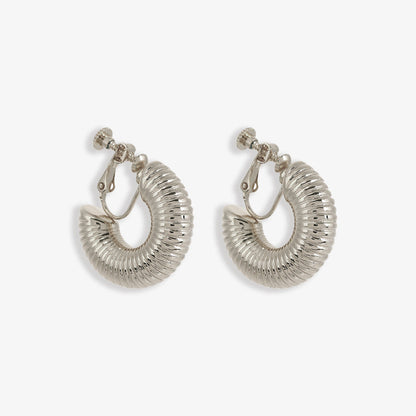 Contemporary silver-finished helix hoop clip-on earrings offering an avant-garde take on the classic hoop. Equipped with a screw-back clip-on for a comfortable fit.