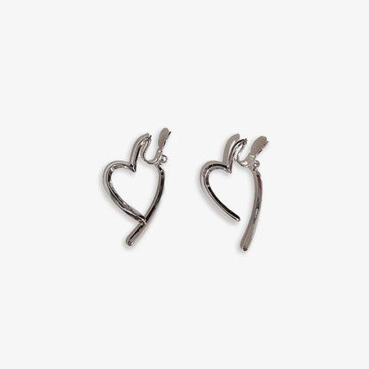 Silver, clip-on heart drop earrings add a touch of romantic flair to any outfit. The sleek design and polished finish create a timeless look. Crafted from alloy with a secure coil clip closure, they're perfect for those with non-pierced ears.