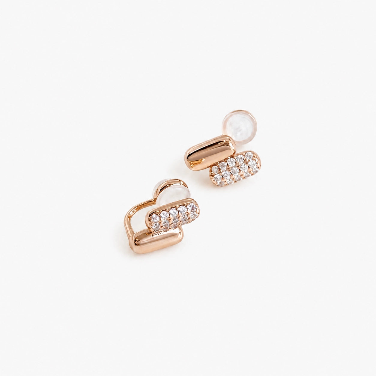 Rose gold earrings with clear zircons, designed as pill-shape