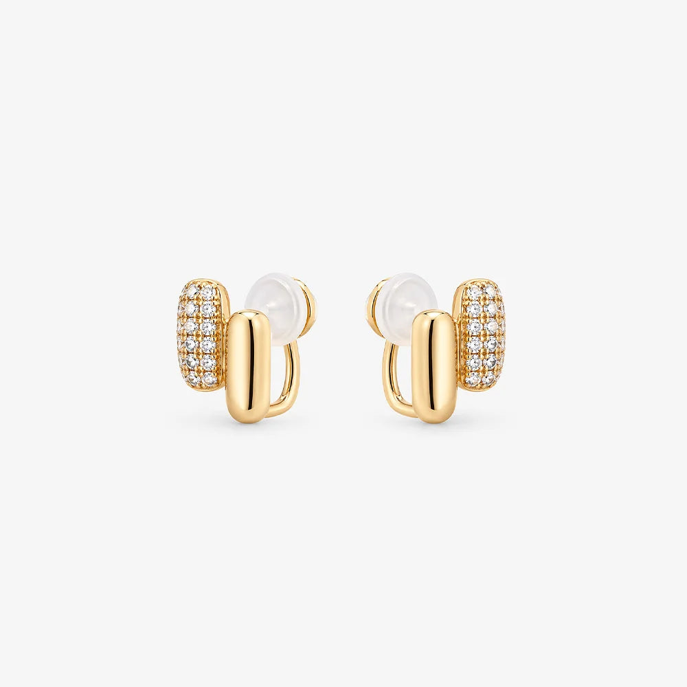 Front view of elongated pill-shaped rose gold huggie earrings with shining pavé cubic zirconia accents on a white background.