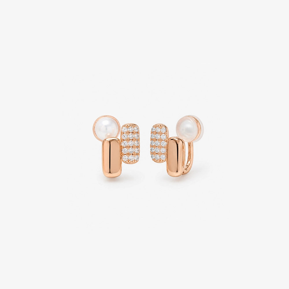 Front view of elongated pill-shaped rose gold huggie earrings with shining pavé cubic zirconia accents on a white background.
