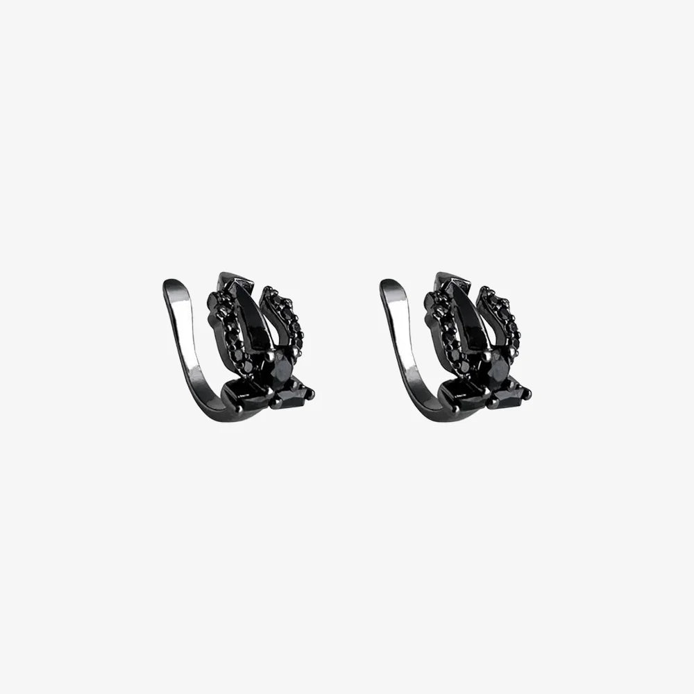 A pair of Shadow Trident black clip-on ear cuffs with black cubic zirconia stones, displayed on a white background to show detail.