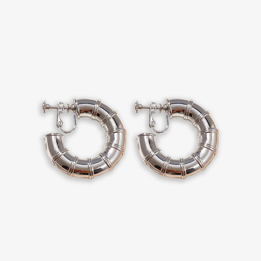 Embrace a touch of nature's elegance with these Silver Bamboo Hoop Clip-On Earrings. Crafted from durable alloy, their iconic design and screw-back closure ensure a comfortable fit for non-pierced ears.