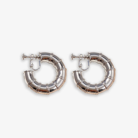 Embrace a touch of nature's elegance with these Silver Bamboo Hoop Clip-On Earrings. Crafted from durable alloy, their iconic design and screw-back closure ensure a comfortable fit for non-pierced ears.