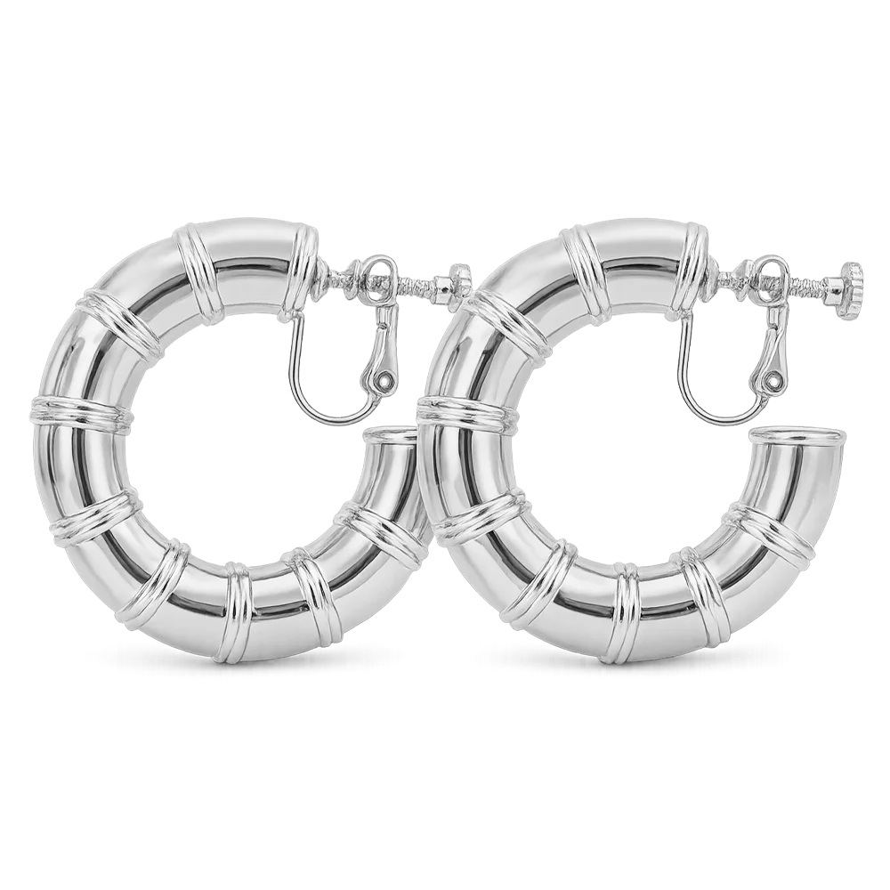 A pair of silver hoop earrings with a bamboo-inspired segmented design, shown on a clean white background.