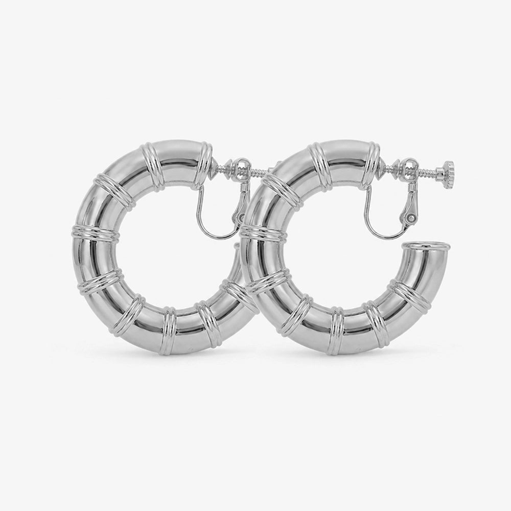 A pair of silver bamboo hoop clip-on earrings with a screw-back mechanism.