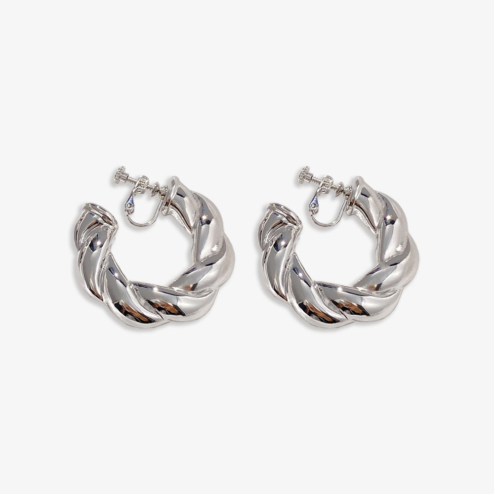 Silver alloy Bold Twist Hoop Clip On Earrings offer a fusion of timeless elegance and contemporary design. Their lustrous silver finish and unique twist pattern, paired with a comfortable screw-back clip-on, add a modern flair to traditional hoop earrings.