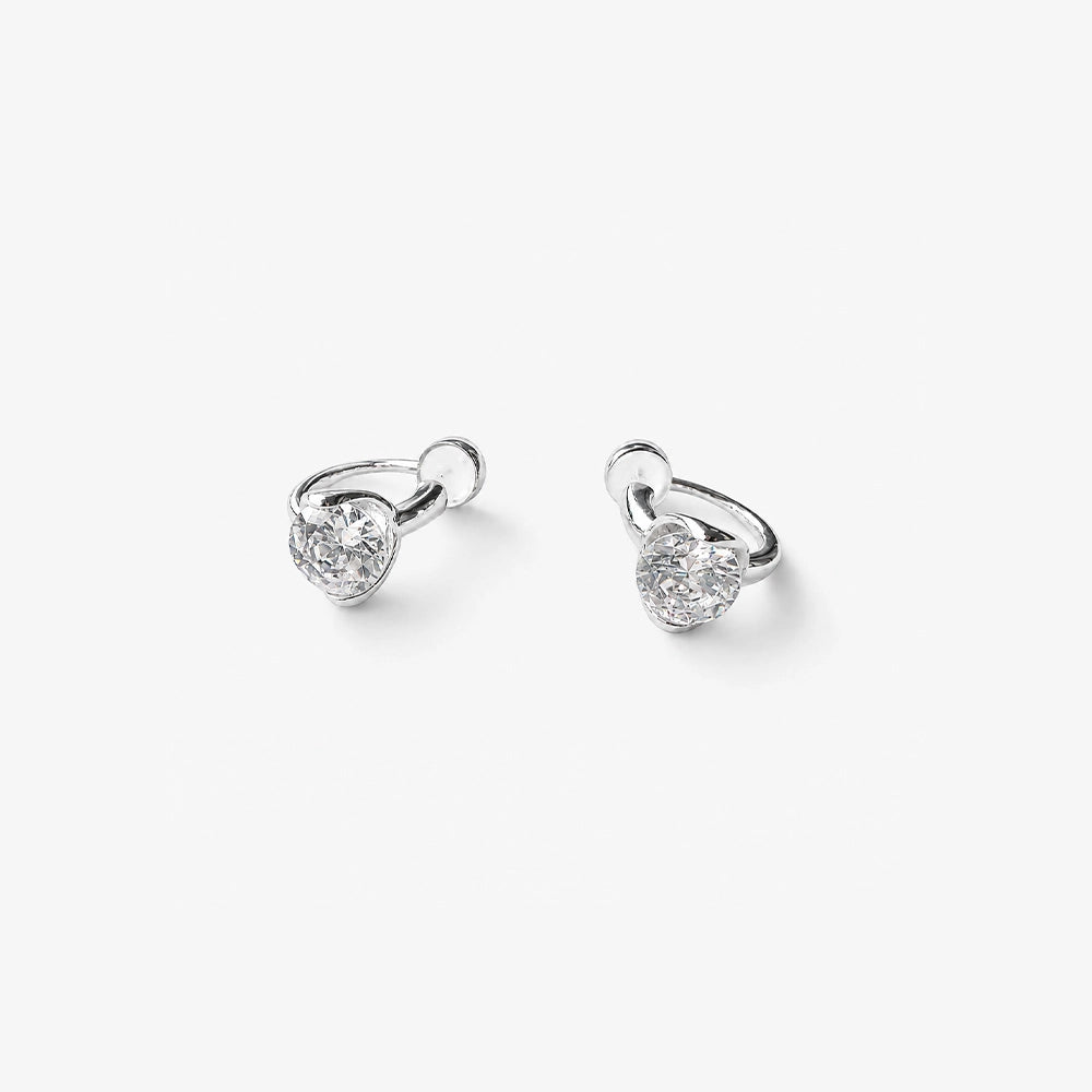 Close up detail of the prong set round cubic zirconia on silver clip on stud earrings