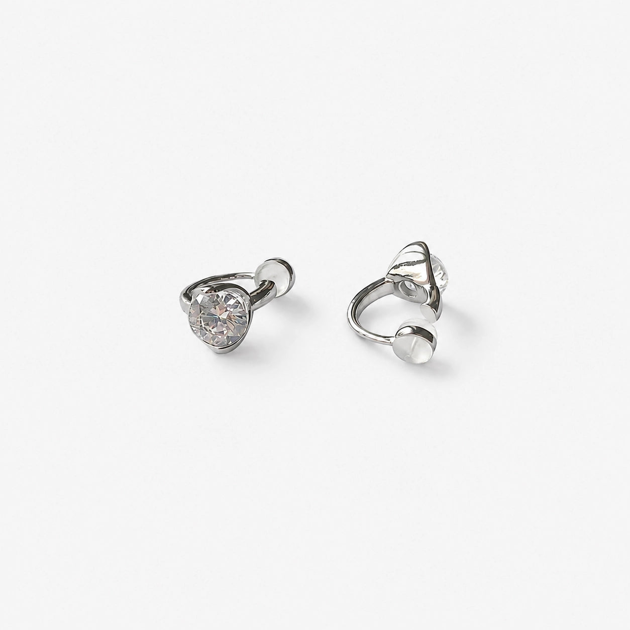 Silver CZ solitaire clip on stud earrings showing the cushioned clip on closure