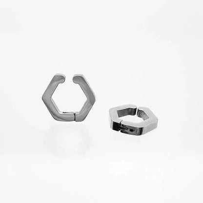 An angled view of the pair of silver geometric earrings for non-pierced ears, highlighting their modern, hexagonal shape and polished finish.