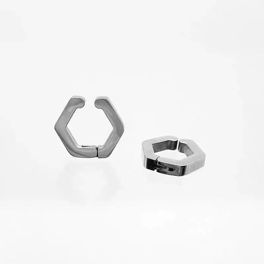 An angled view of the pair of silver geometric earrings for non-pierced ears, highlighting their modern, hexagonal shape and polished finish.