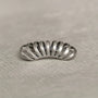 Silver Gothic Helix Ear Cuff top view on white textile background, metallic finish