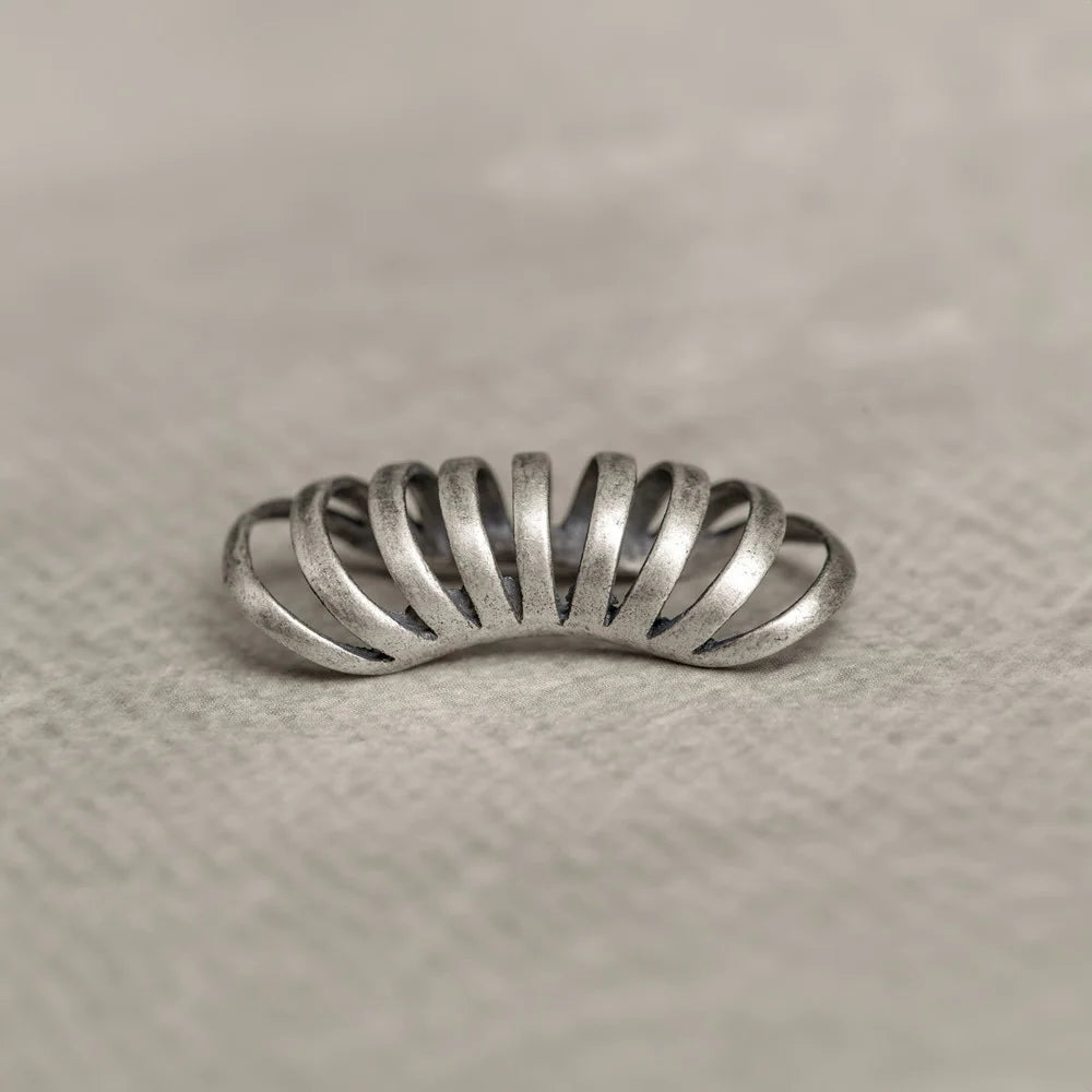 Silver Gothic Helix Ear Cuff top view on white textile background, metallic finish