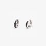Angled view of unisex silver greek key clip on huggie earrings for non pierced ears