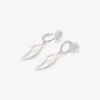 Angled detail of silver leaf drop clip on earrings and cushioned clip closure
