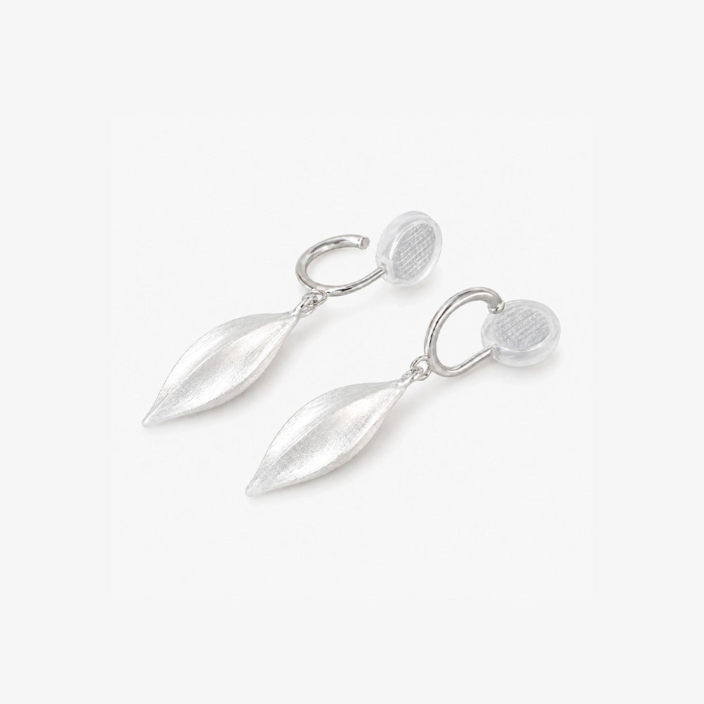 Angled detail of silver leaf drop clip on earrings and cushioned clip closure