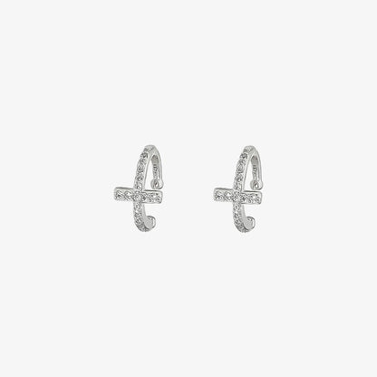 A single silver pavé cross clip-on ear cuff, adorned with sparkling cubic zirconia, shown isolated on a white background.