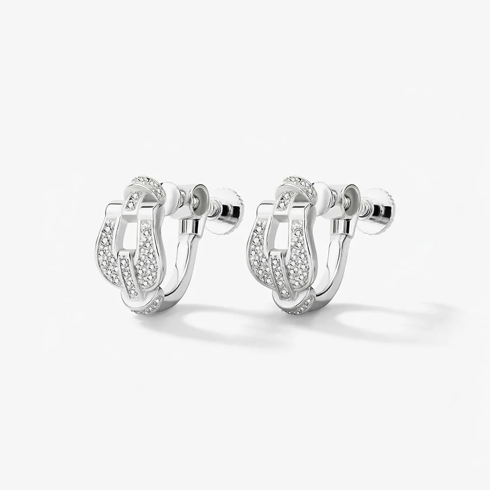 A studio shot of a pair of Silver Pave Horseshoe Clip On Earrings against a white background, highlighting the sparkling pave stones and the clip-on mechanism.