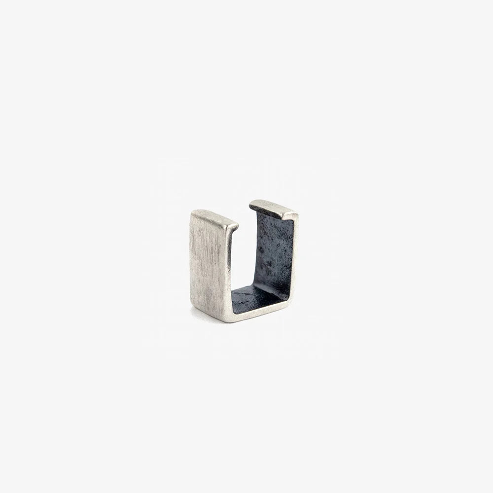 A single, small minimalist bar ear cuff in a brushed 925 sterling silver finish, shown isolated on a white background.