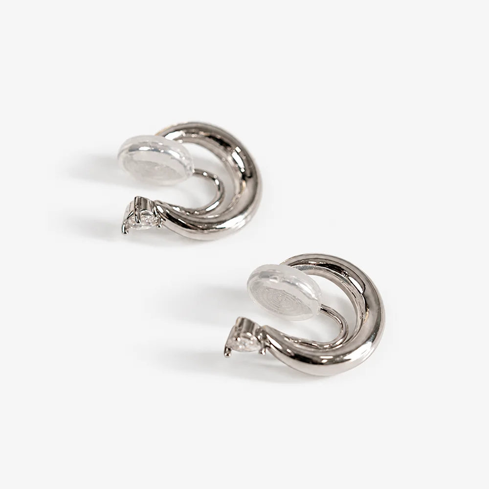 Small thick hoop clip-on earrings showing the U-Type clip and clear resin pad behind the heart CZ